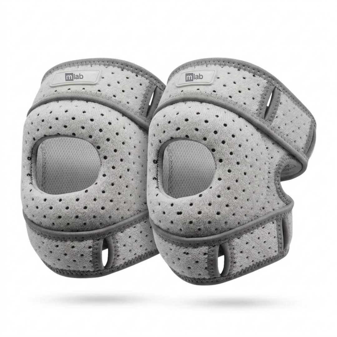 A pair of gray athletic knee sleeves with a perforated mesh design and adjustable straps, shown on a white background.
