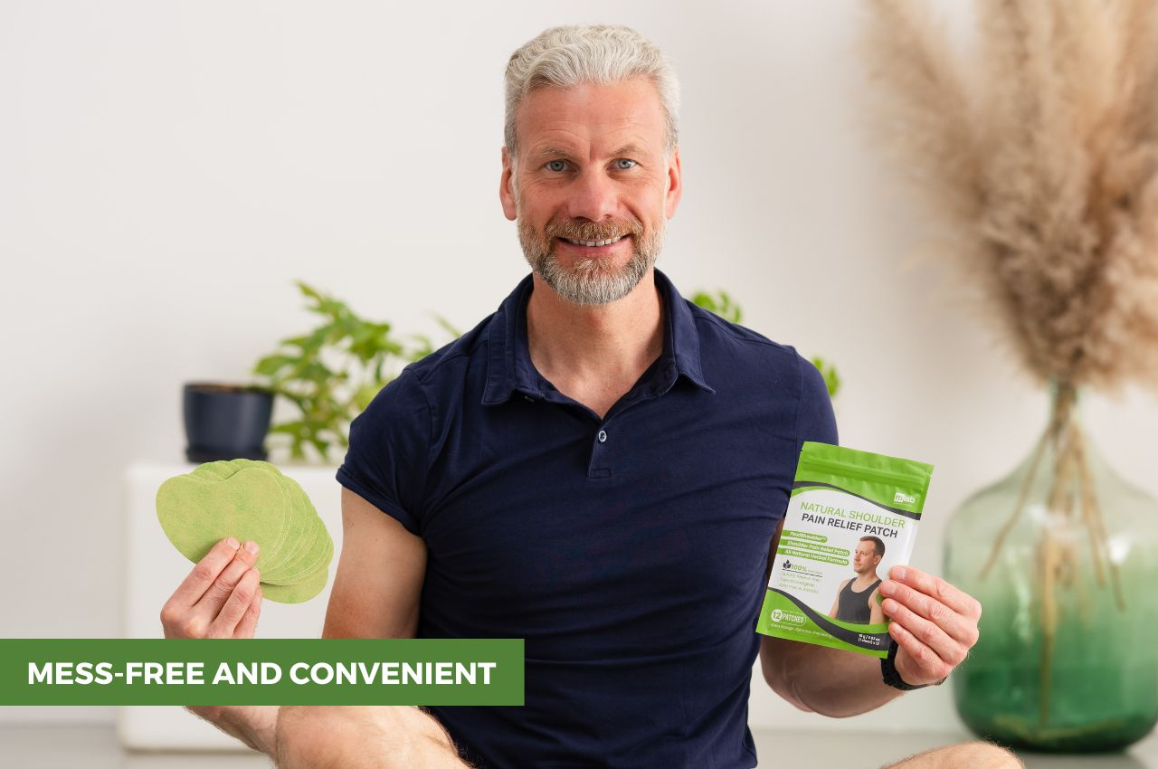 Man looking at the camera and smiling while holding FlexiShoulder packaging and patches